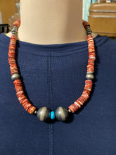 This Spiny oyster necklace is 20 inches. It has disc and Navajo pearls plus one piece of sleeping beauty turquoise.