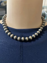 A 16 inch 10 mm Navajo pearls necklace with a 3 inch extender