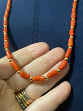 Red coral oblong beads and 12 carat gold filled beads and clap.  24 inches