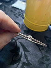 The sterling silver plain with a twist bangle