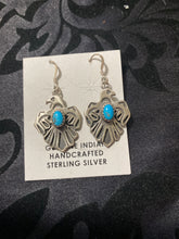 The sterling silver Thunderbird with a small stone of turquoise in each earrings