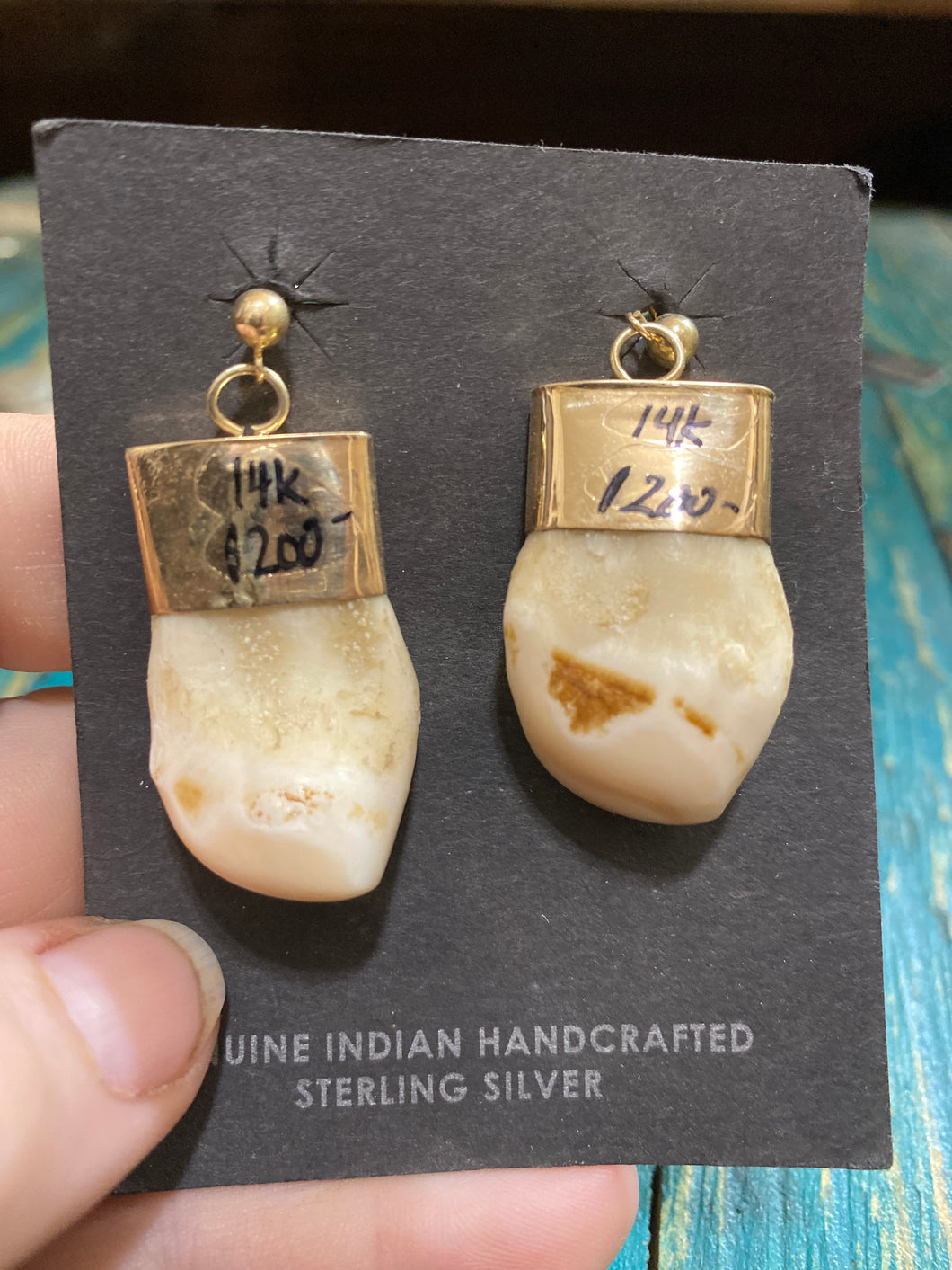 The 14k Gold Elk Ivory earrings.