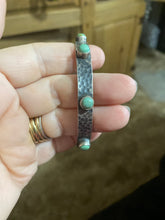 Hammered sterling silver with snake eyes turquoise pieces on a bangle
