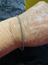 The sterling silver plain with a twist bangle