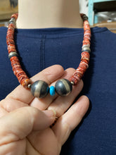 This Spiny oyster necklace is 20 inches. It has disc and Navajo pearls plus one piece of sleeping beauty turquoise.