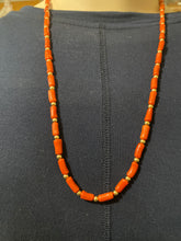 Red coral oblong beads and 12 carat gold filled beads and clap.  24 inches