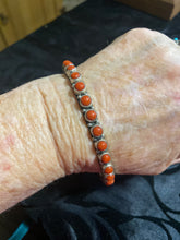 The small round stone Coral bangle bracelet