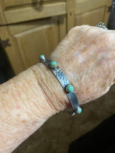 Hammered sterling silver with snake eyes turquoise pieces on a bangle