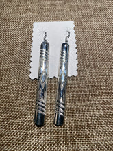 The long slender sterling silver earrings