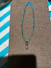 Turquoise Heishi beads beads with a silver squash bloom Pendant