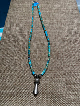 Turquoise Heishi beads beads with a silver squash bloom Pendant