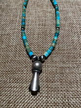 Turquoise Heishi beads beads with a silver squash bloom Pendant