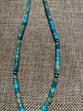 Turquoise Heishi beads beads with a silver squash bloom Pendant