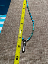 Turquoise Heishi beads beads with a silver squash bloom Pendant