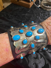Leather,Sterling silver concho and sleeping beauty Turquoise in a beautiful bow guard!