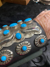Leather,Sterling silver concho and sleeping beauty Turquoise in a beautiful bow guard!