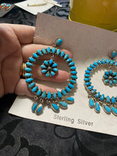 The giant turquoise circle earrings with an inside dangle in a post earring