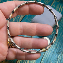 The sterling silver twisted bangle