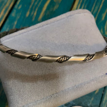 The sterling silver twisted bangle